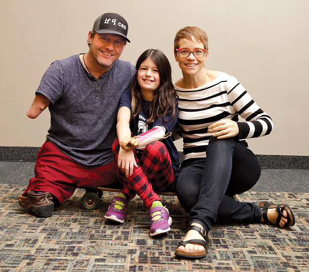 War Amps Regional Representatives Chris Koch and Christine McMaster sitting with Champ Sophia at a CHAMP Seminar.